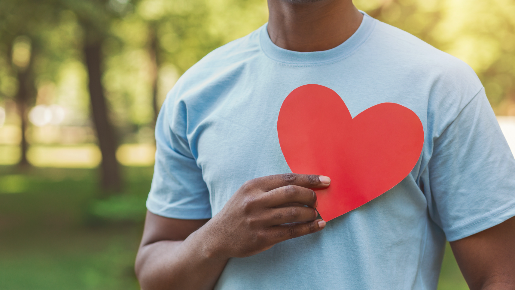 man holding a heart to his chest