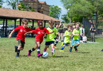 Young soccer players compete in a friendly match wearing newly branded CITY SC and Gateway Region YMCA jerseys.