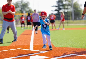 YMCA Adaptive Sports Complex Boy Scoring at Home Base