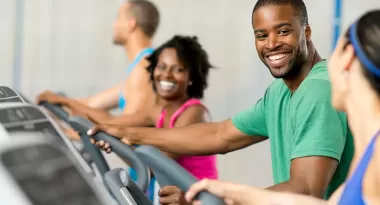 a group of people working out on elliptical machines at the ymca 