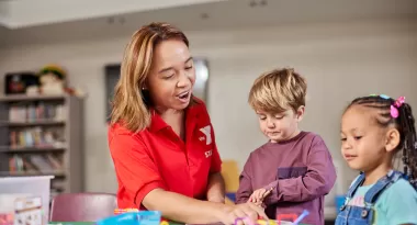 Children and YMCA Staff Member Doing an Art Project in Child Watch