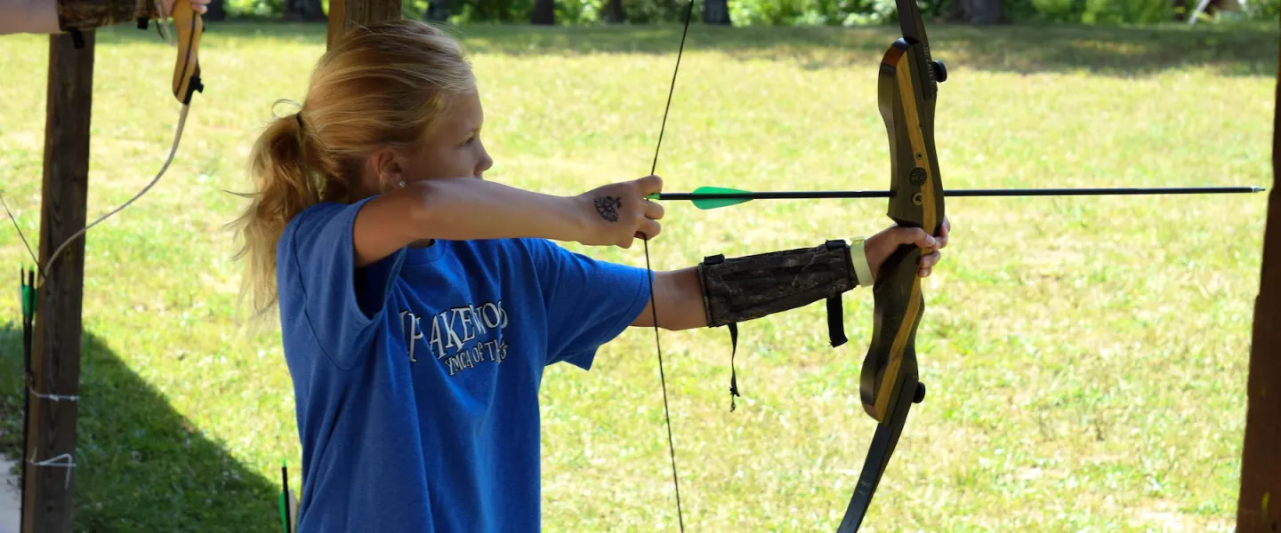 ymca camp lakewood archery bow and arrow drawn at target