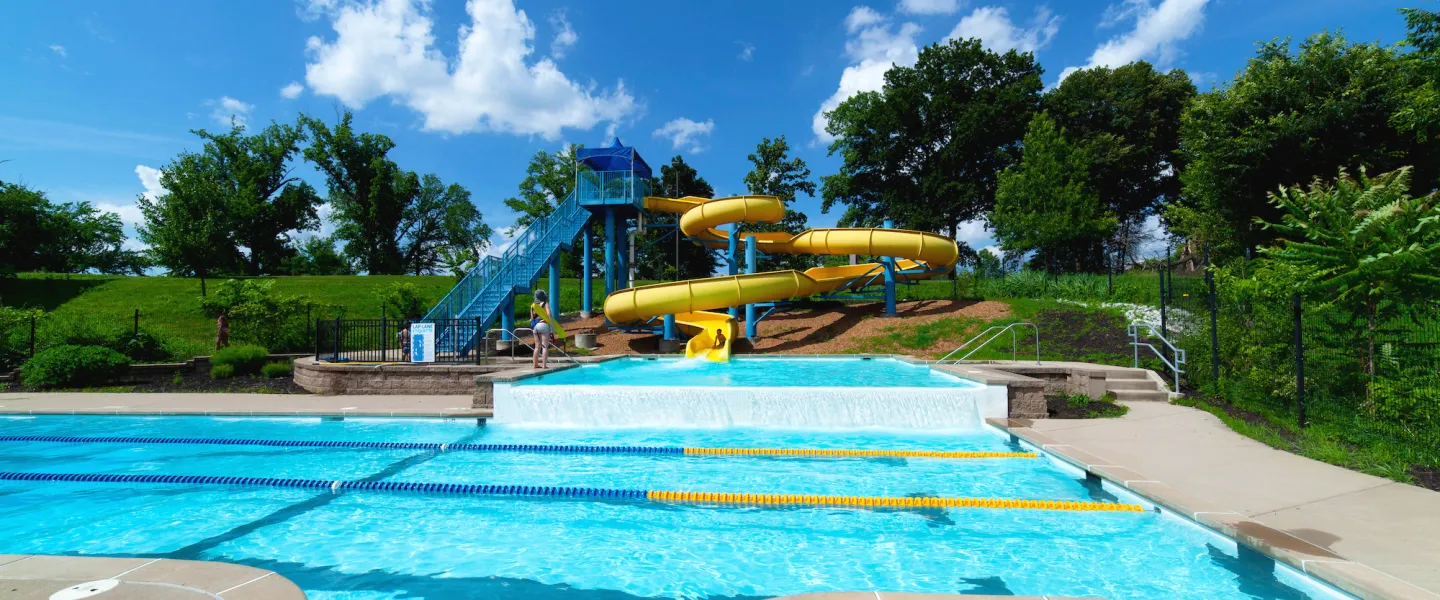 Carondelet Park Rec Complex Gym St. Louis, MO Outdoor Aquatic Center featuring a 2.5-story yellow water slide
