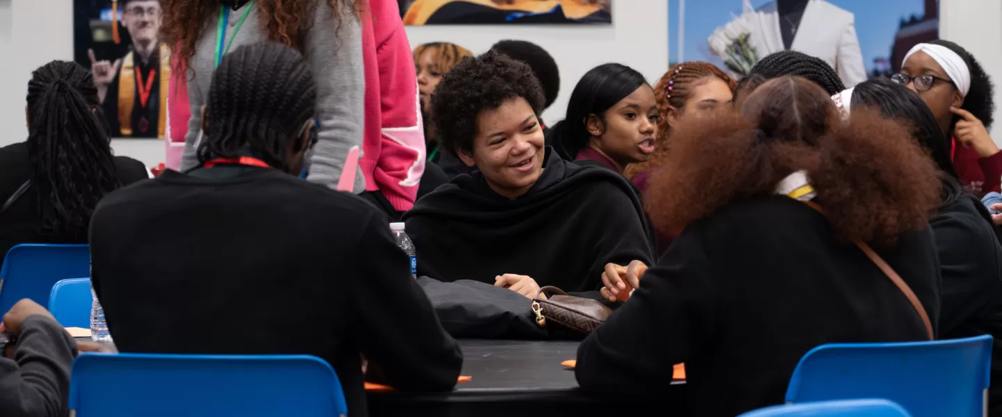 Committee Breakout Session – Small groups of students sit around tables, engaged in discussions and reviewing notes while drafting legislative proposals.