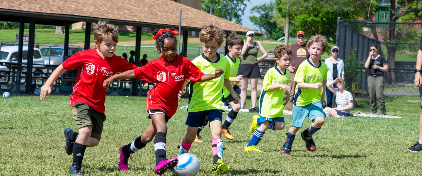 Young soccer players compete in a friendly match wearing newly branded CITY SC and Gateway Region YMCA jerseys.