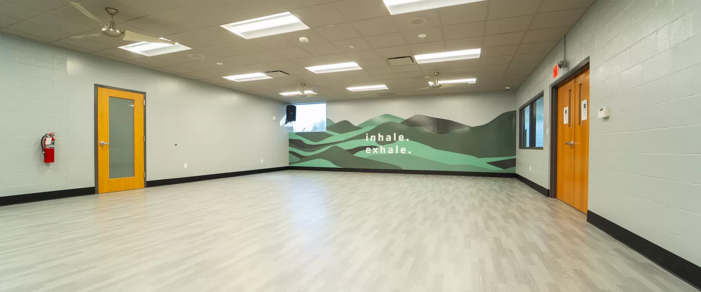 Chesterfield Family YMCA gym's brand new group exercise studio featuring new flooring and "Inhale. Exhale." motivational wall decal.