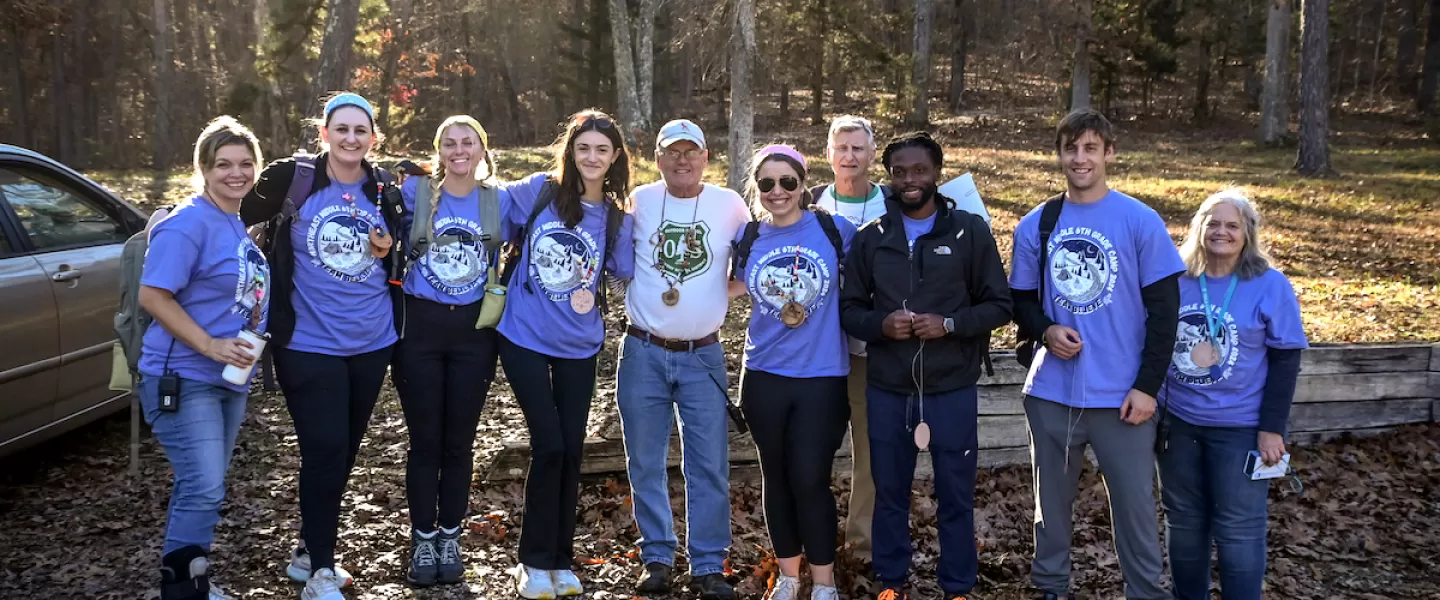 Group of teachers standing together and smiling during school retreat