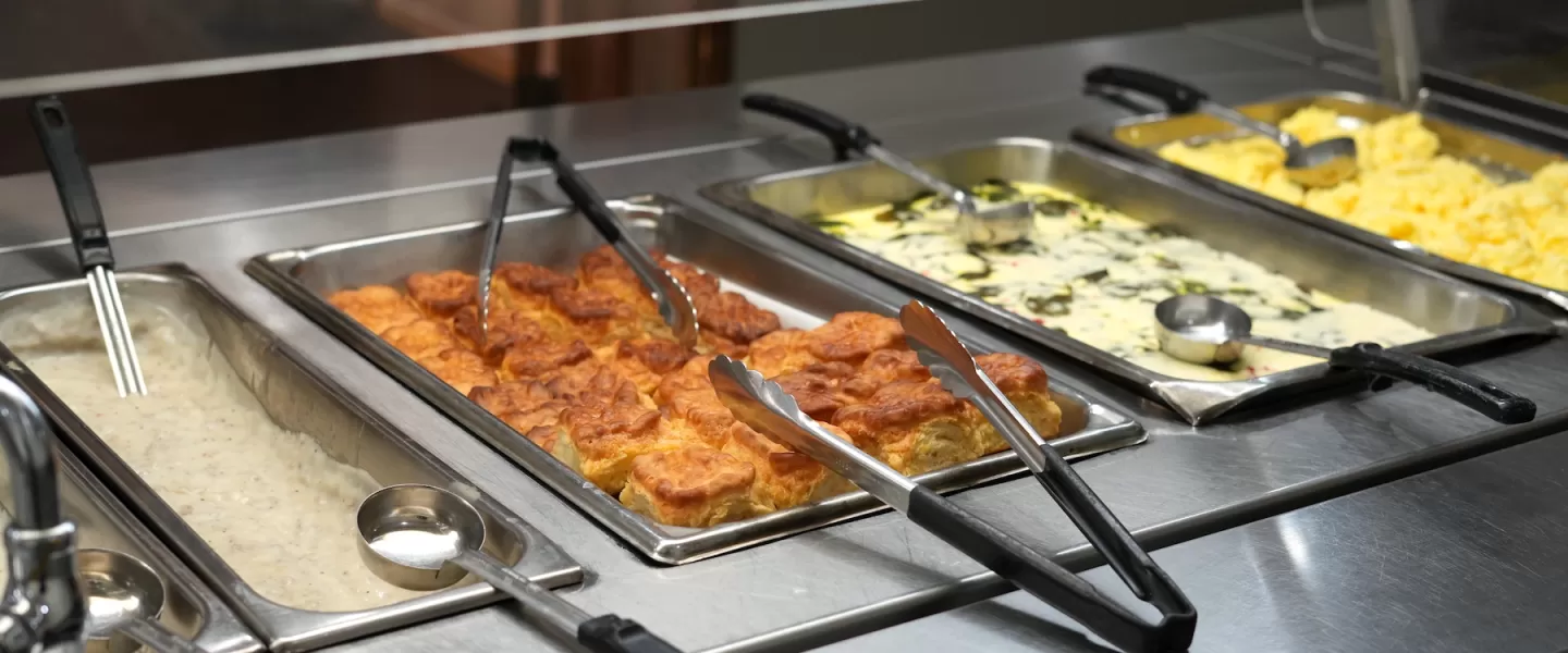 Morning breakfast buffet featuring biscuits and gravy and scrambled eggs