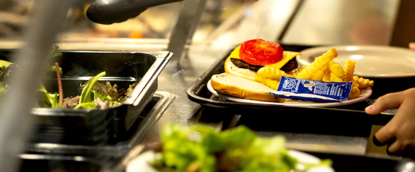 Salad bar featuring greens, vegetable toppings, and a variety of dressings