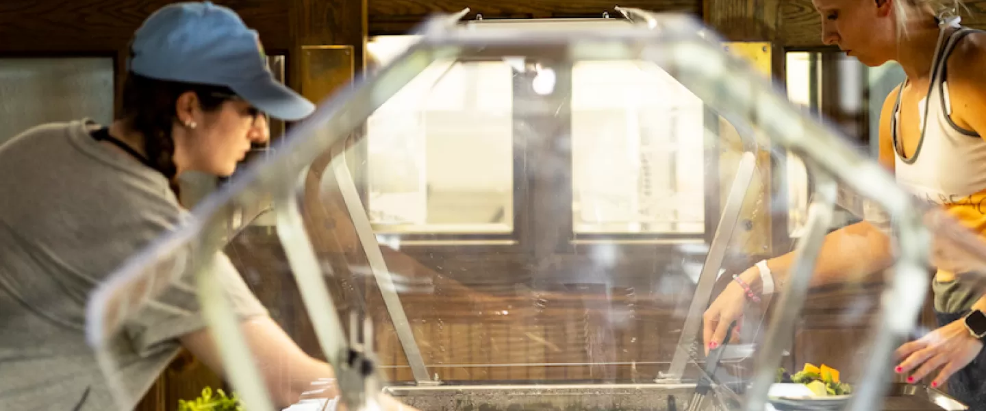 Two women serving themselves at Trout Lodge’s buffet-style dining hall