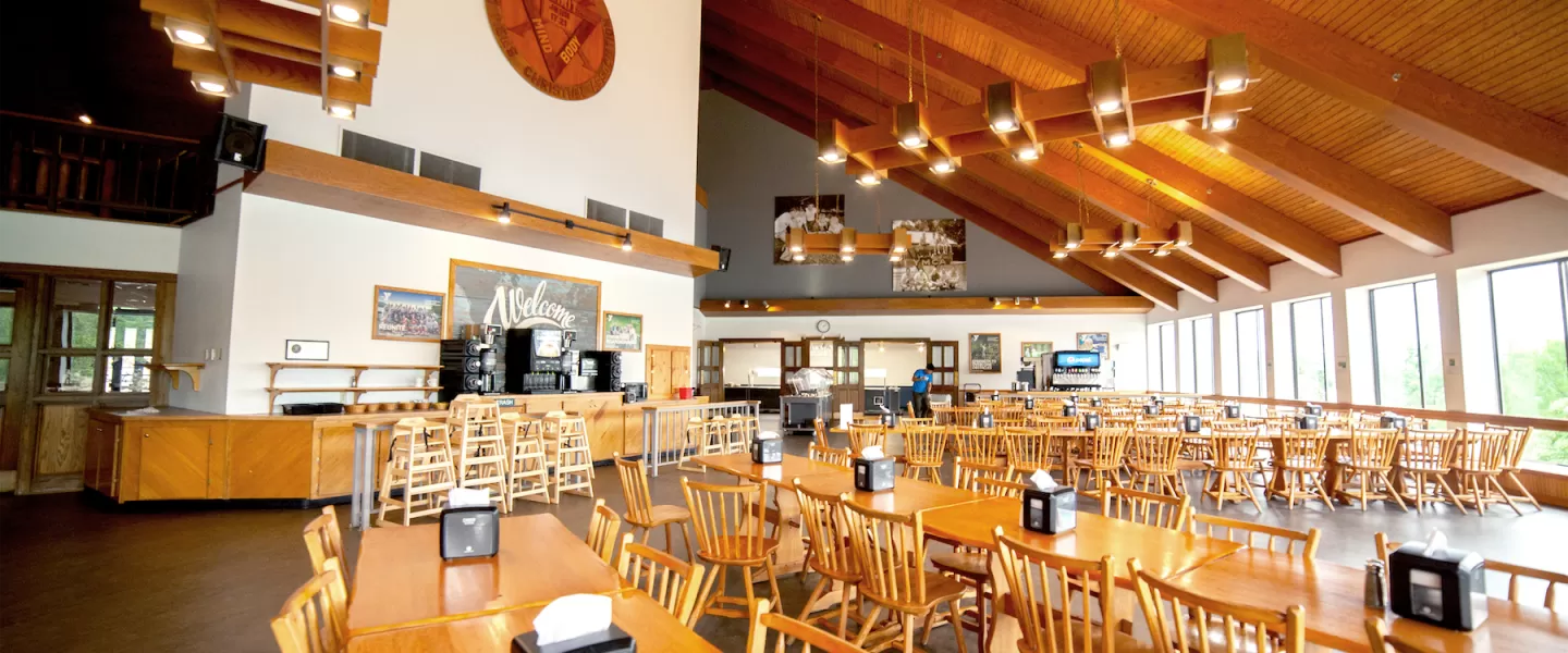 Spacious YMCA Trout Lodge Dining Hall with tables and natural lake-view lighting