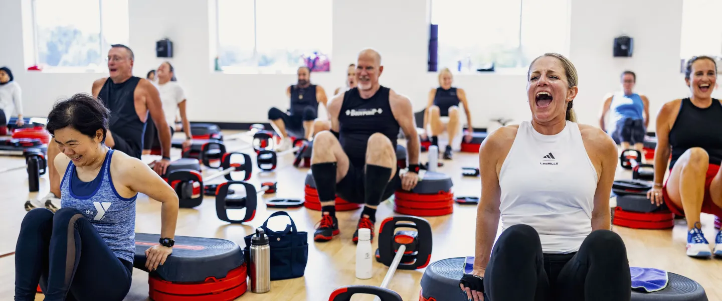 Participants laughing in an intense YMCA LesMills BODYPUMP group exercise class