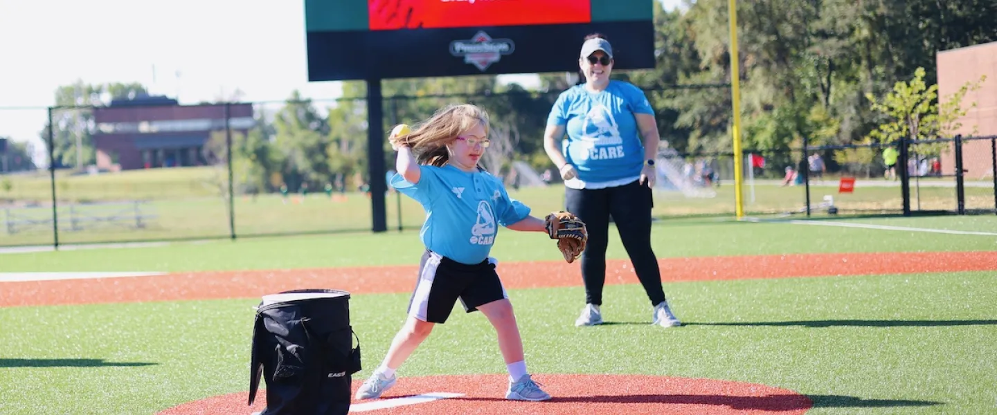A young athlete throws out the first pitch at the the South County YMCA's Adaptive Sports Complex