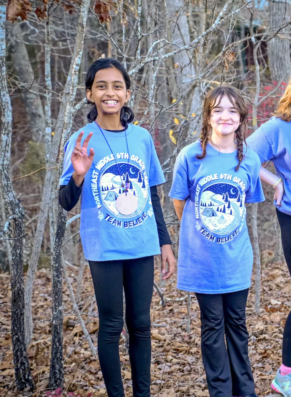 Group of smiling students posing together outdoors during Outdoor Education camp