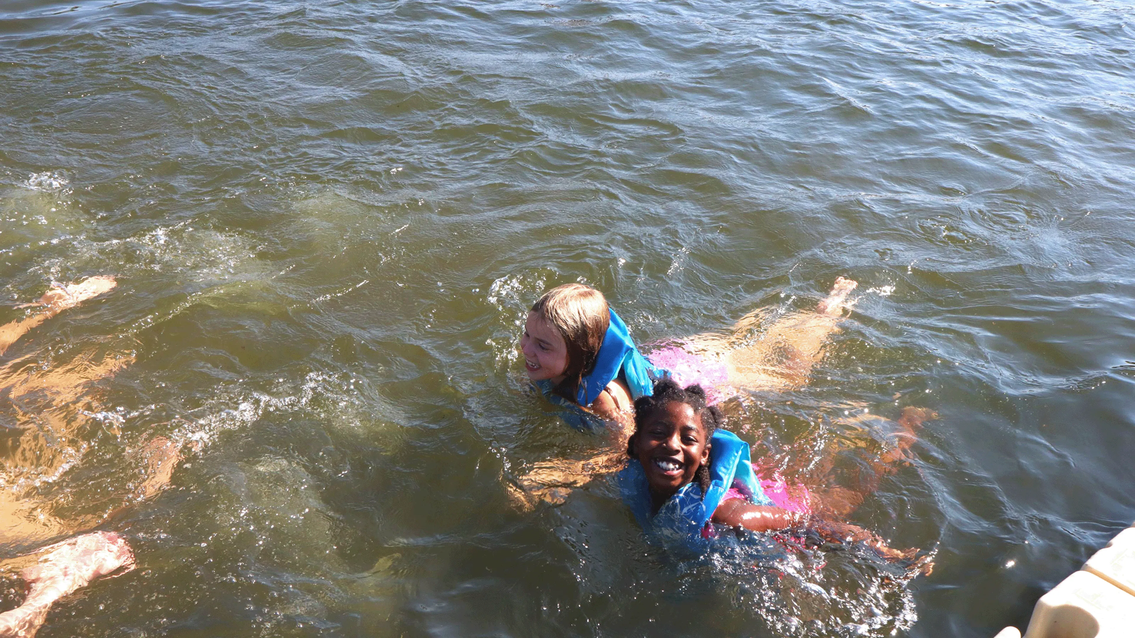 Two friends swimming in YMCA Camp Lakewood's private lake, Sunnen Lake, in Potosi, MO