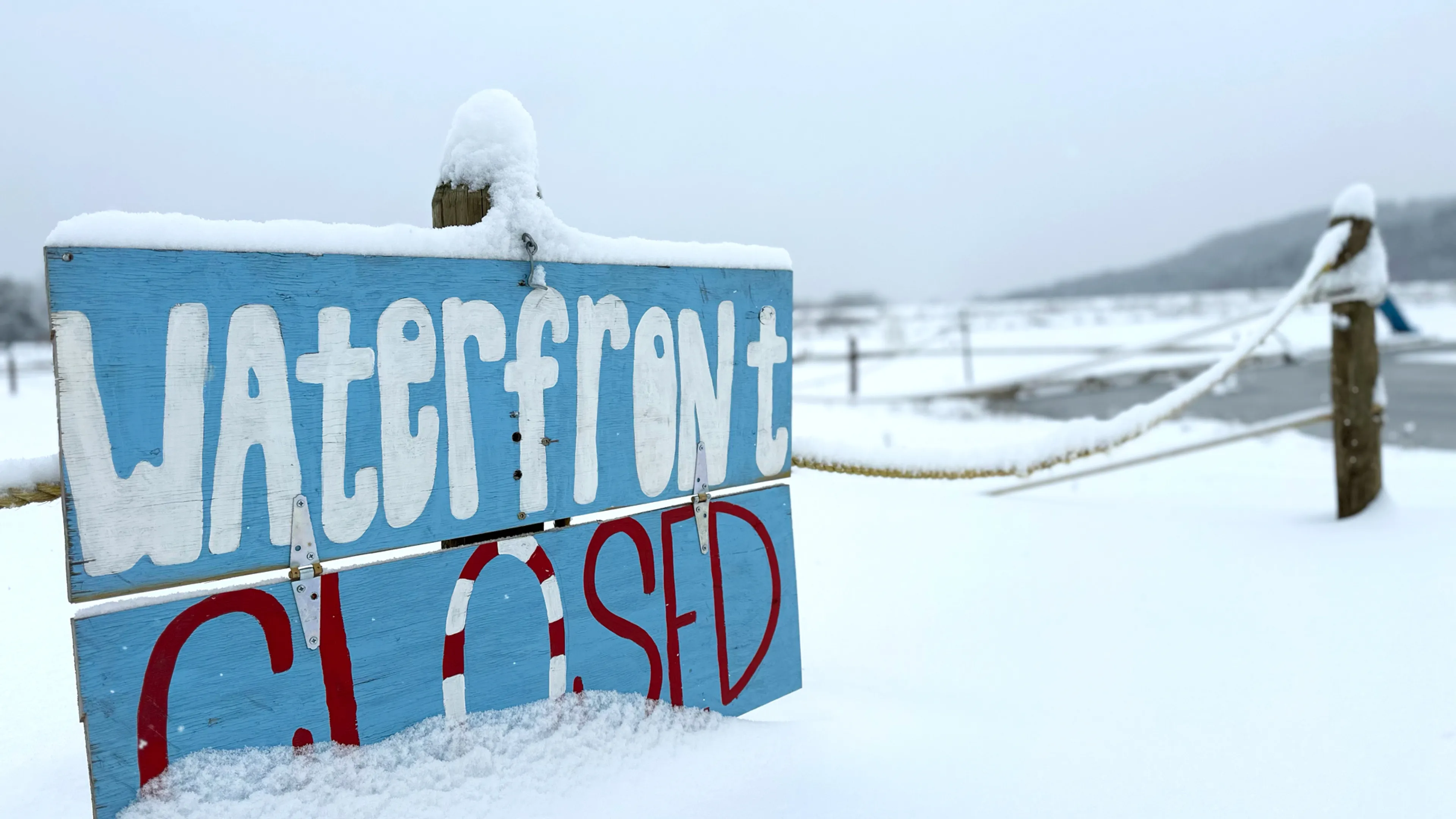 YMCA Trout Lodge Waterfront Closed Sign covered in Winter snow