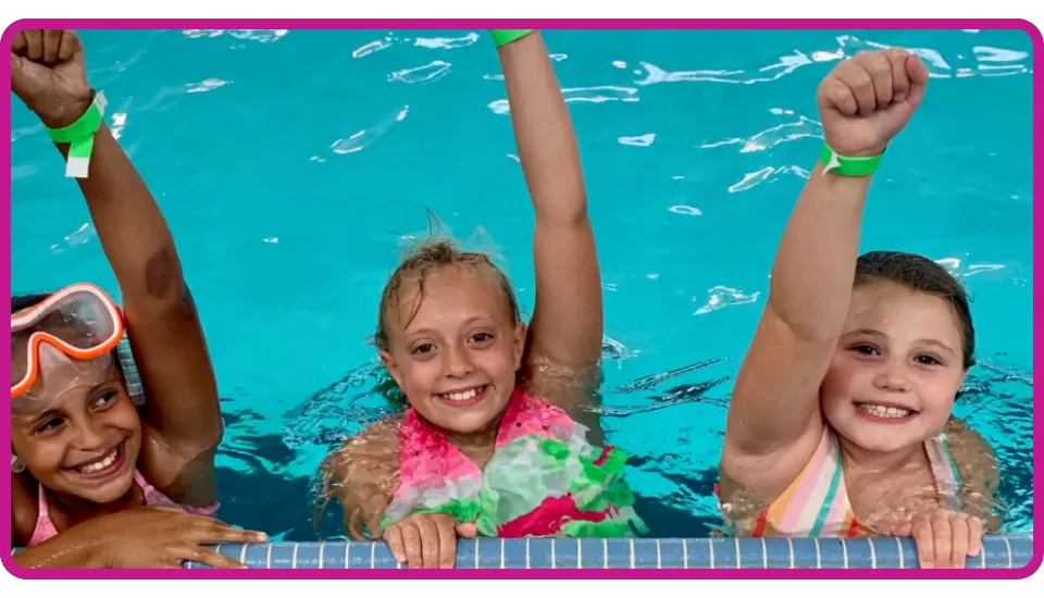 young girls at YMCA smiling after passing their swim test