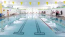 Thumbnail: Indoor pool with up to 6 lap lanes. Pool weights and kickboards in bins beside pool. Separate whirlpool in back of pool area.