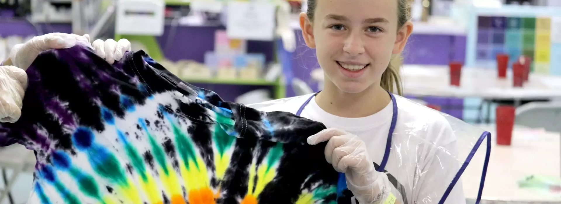 Teen girl tie dying a tshirt