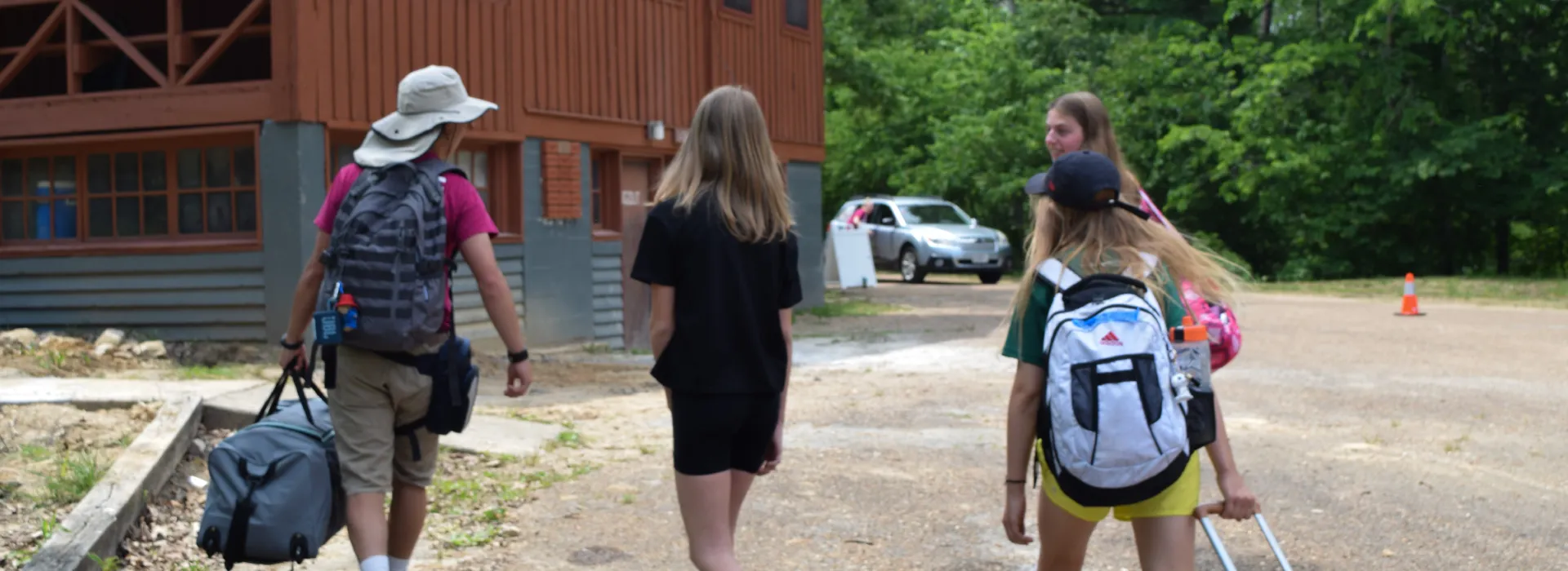 Campers arriving at camp with backpacks