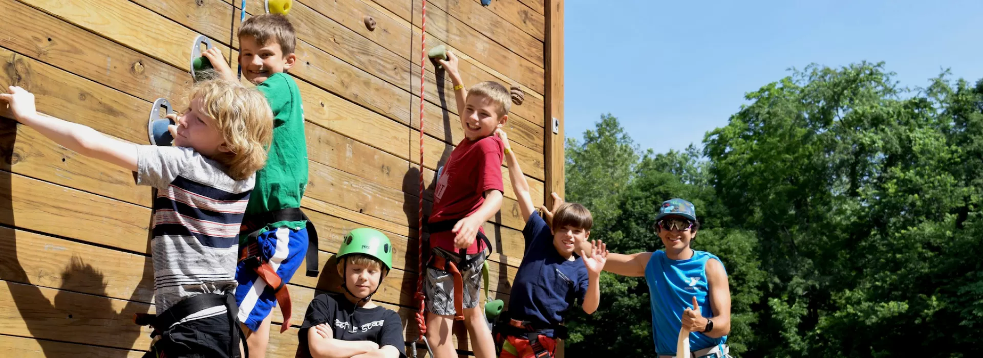 ymca camp lakewood boys climbing on the rock-wall climbing tower