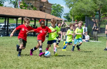 Young soccer players compete in a friendly match wearing newly branded CITY SC and Gateway Region YMCA jerseys.