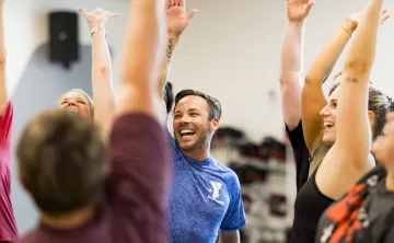 ymca instructor and members high fiving